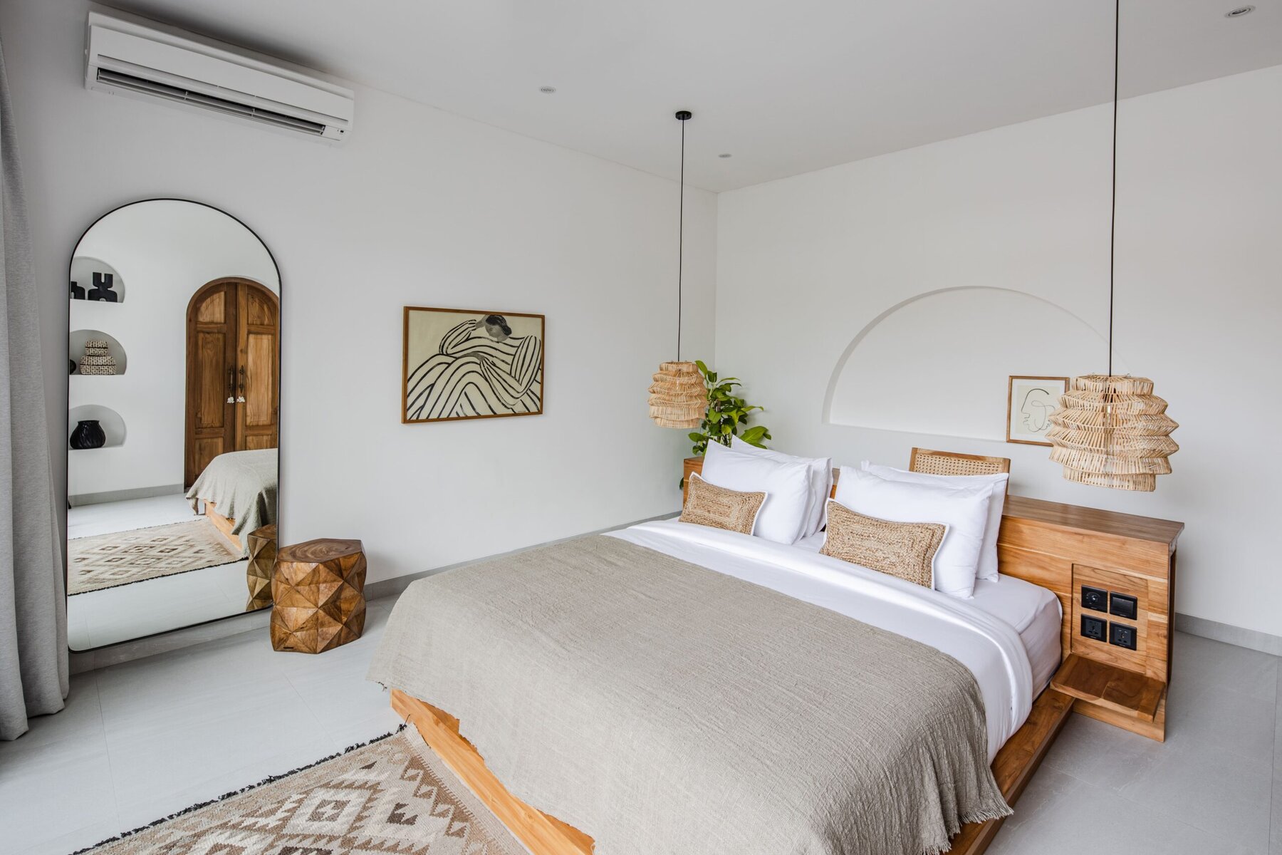 Luxurious tropical minimalist bedroom with wooden furniture and modern decor in Bali.