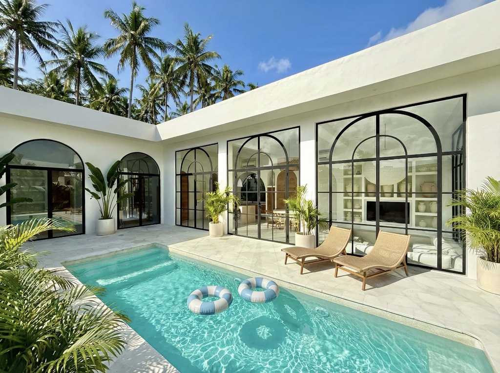 Beautiful Uluwatu villa with a private pool, large glass windows, and tropical decor.