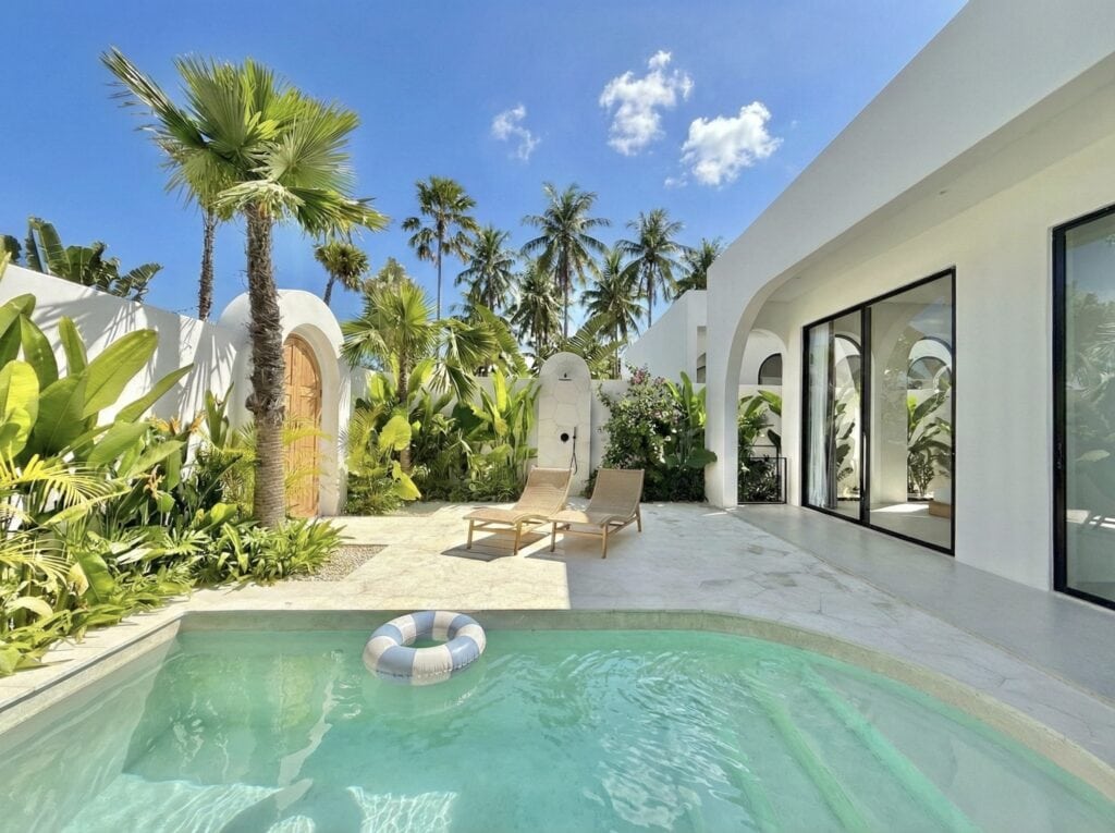 The Young Villas: Luxury tropical-modern rentals in Uluwatu, Bali, showcasing a serene poolside scen.