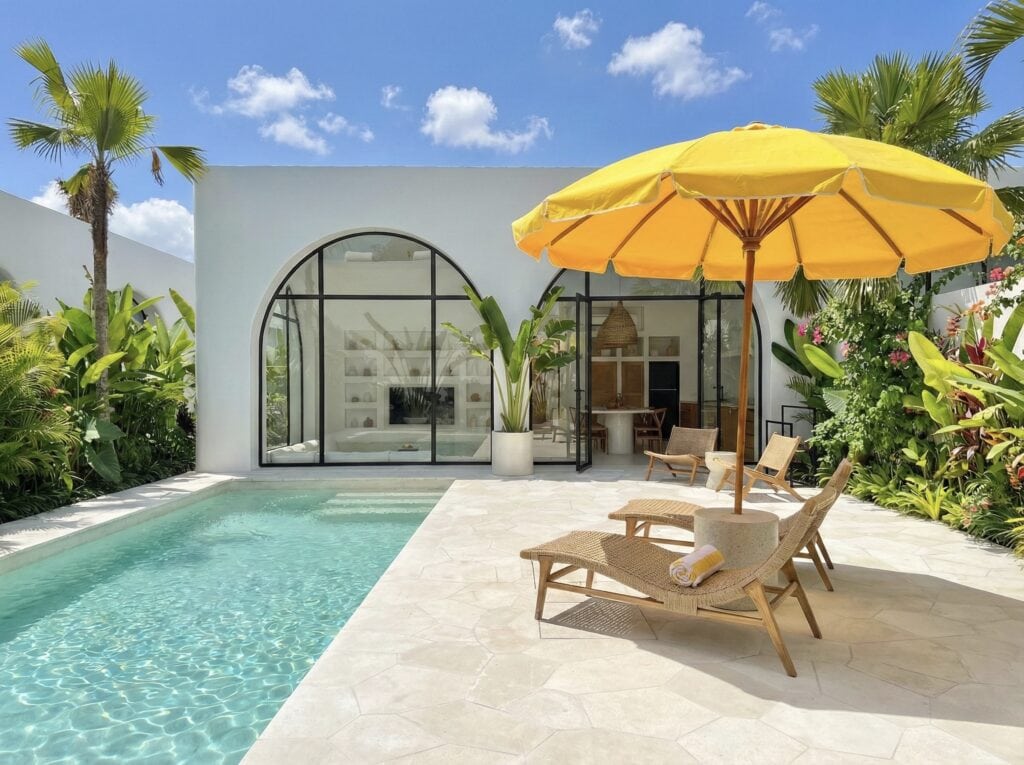The Young Villas: Elegant tropical-modern villa with private pool and sun loungers in Uluwatu, Bali.