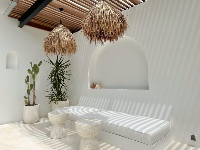 Seaside-inspired modern decor with natural textures, bright white color palette, and tropical elements.