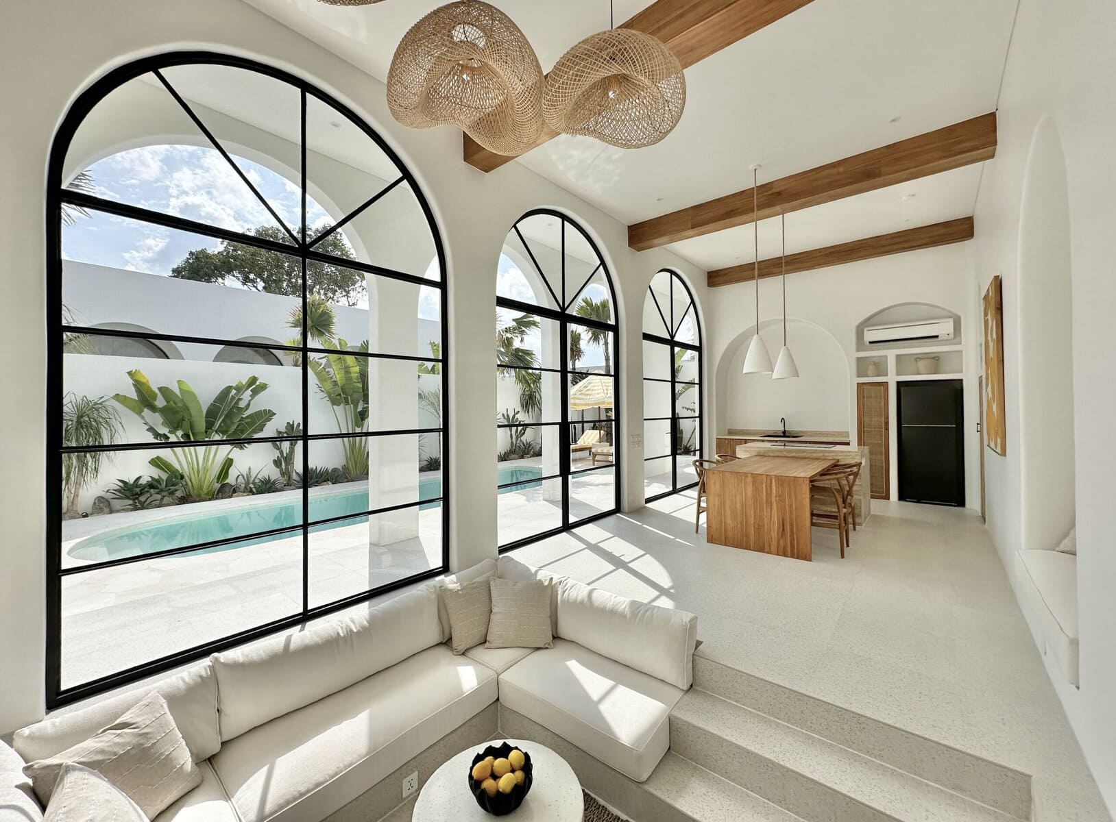 Bright, modern living room with high arched windows and stylish decor.