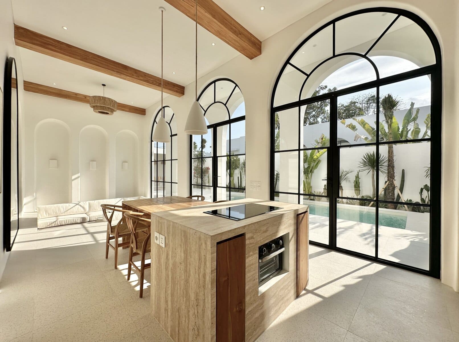 Bright, airy interior with high-end finishes, large arched windows, and tropical views.