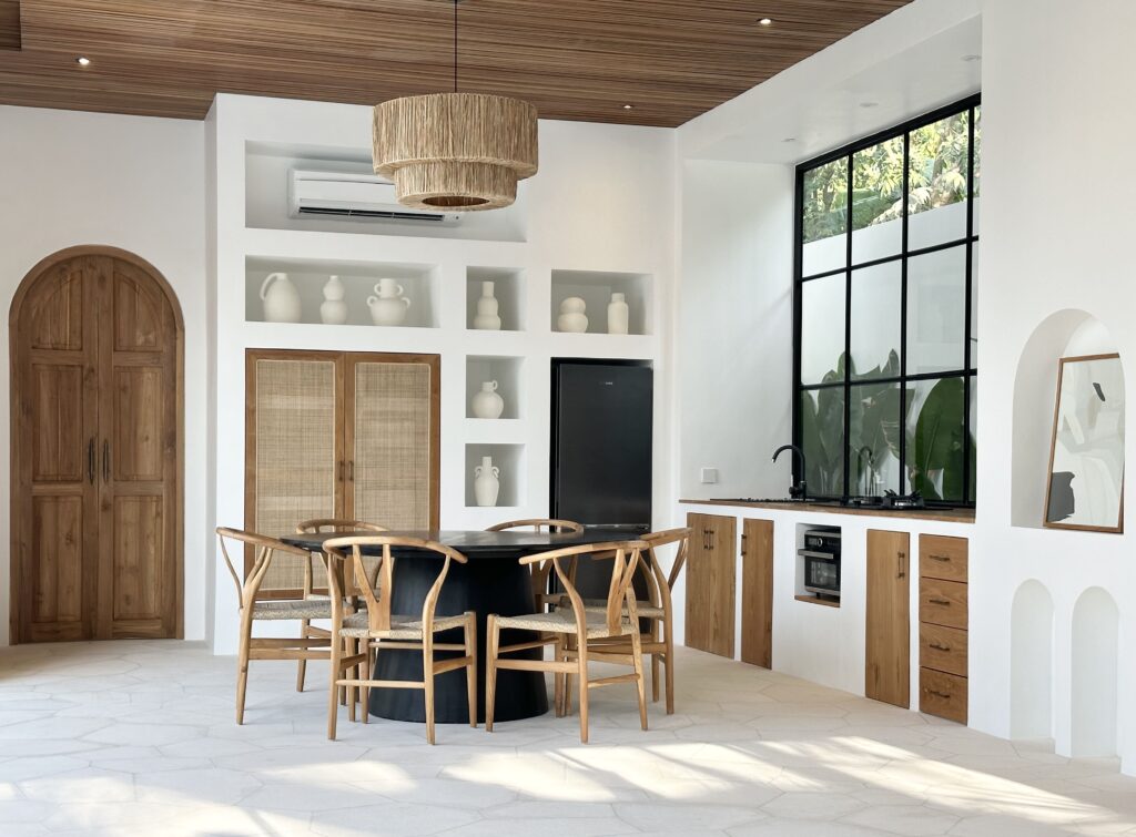 Bright, modern kitchen and dining area with large windows and elegant decor.