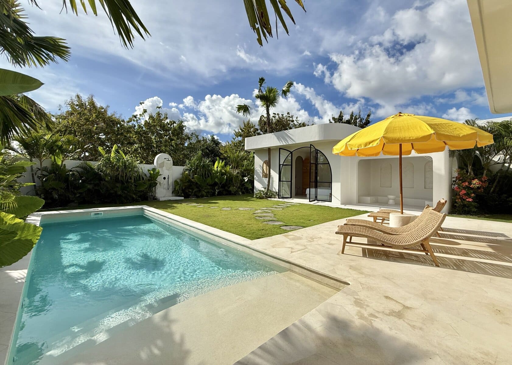 Modern tropical four-bedroom villa in Uluwatu, Bali, featuring a private pool and lush garden.