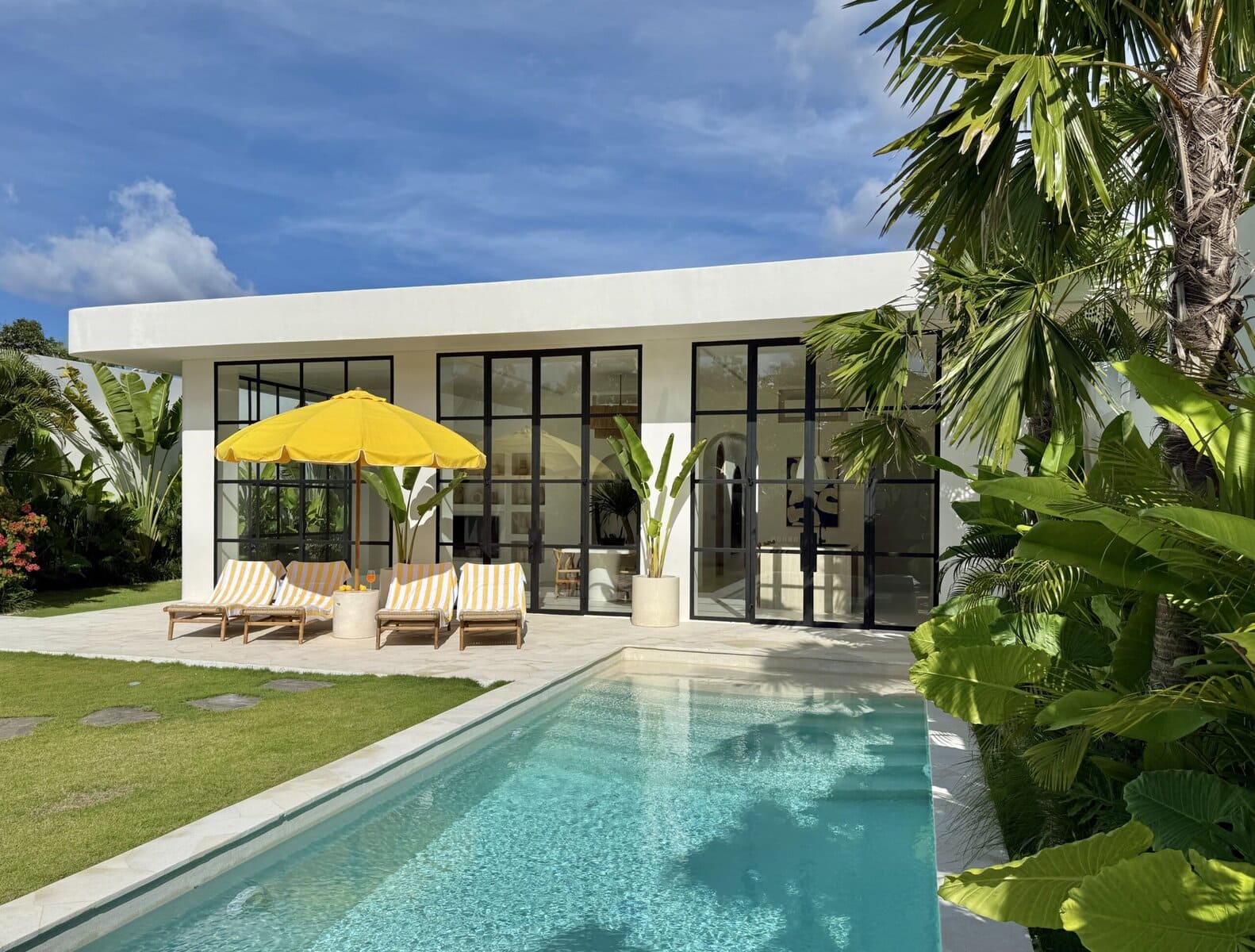 Bright modern villa with sleek design, outdoor pool, and tropical greenery. Perfect Uluwatu retreat.