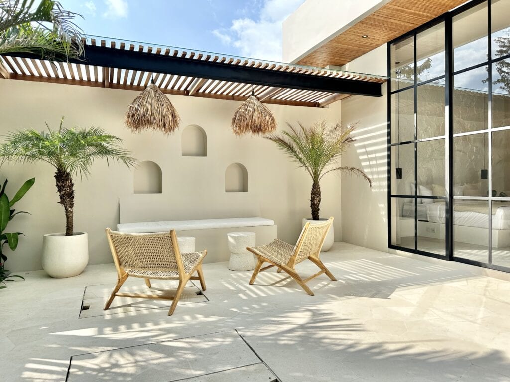 Stunning Bali villa with tropical-modern style, featuring outdoor seating and lush greenery.