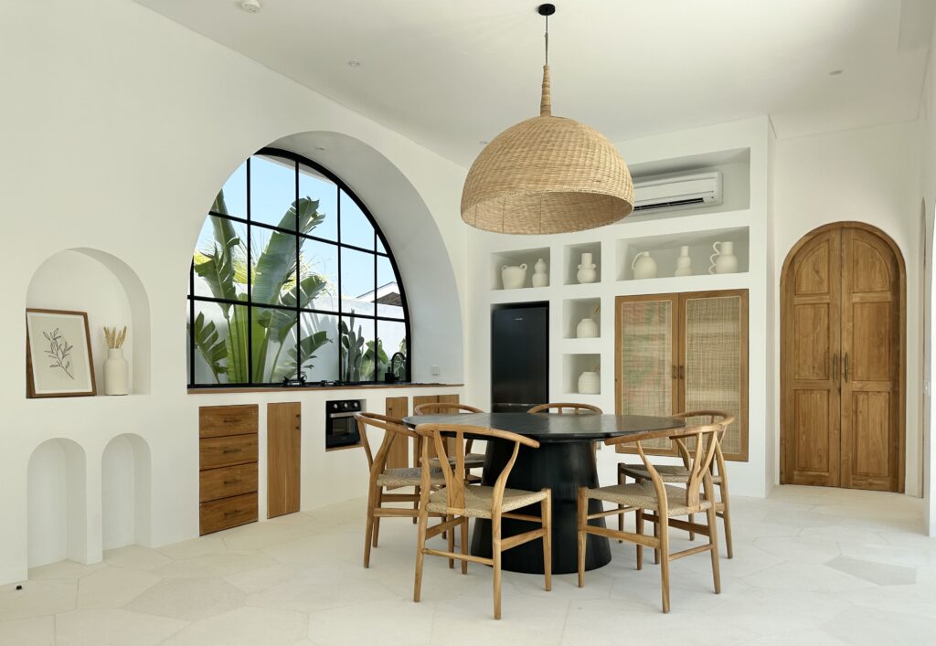 Bright, airy minimalistic interior showcasing a stylish kitchen and dining area with natural accents.