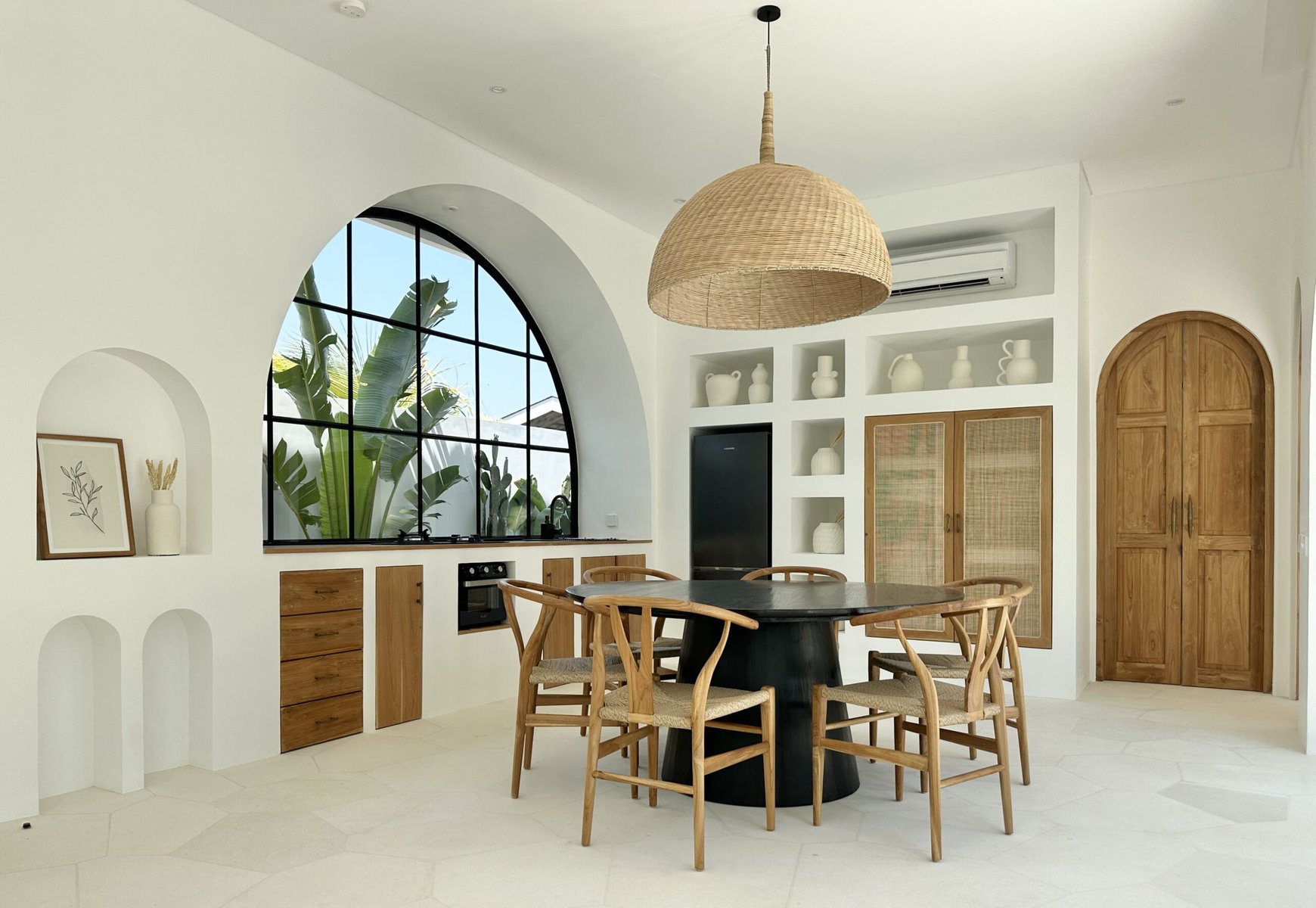 Bright, airy minimalistic interior showcasing a stylish kitchen and dining area with natural accents.