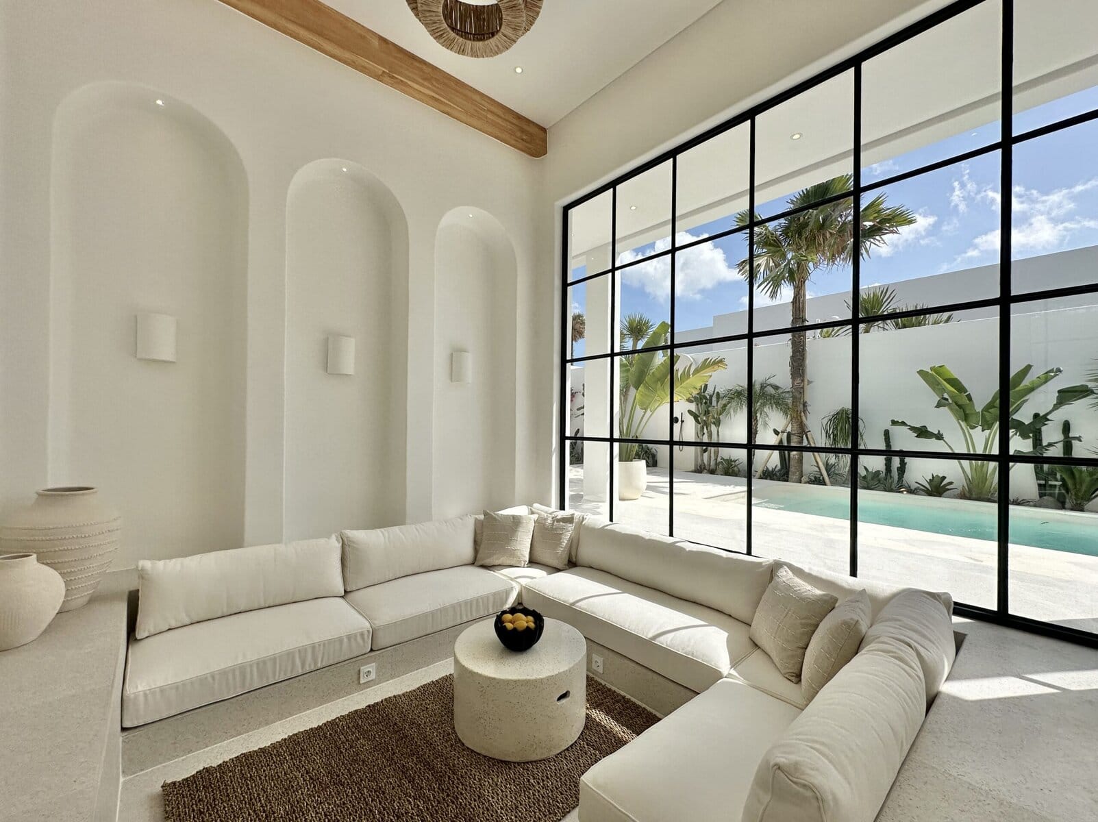 Modern tropical design with spacious living area and large glass windows.