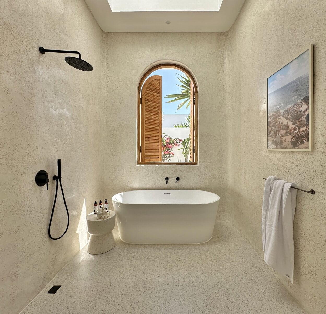 Bright, modern bathroom with bathtub and beach views.