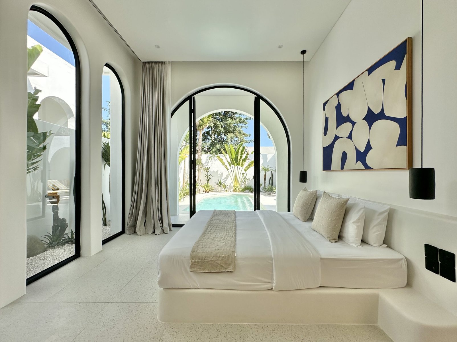 Elegant bedroom with pool view in Bingin villa.