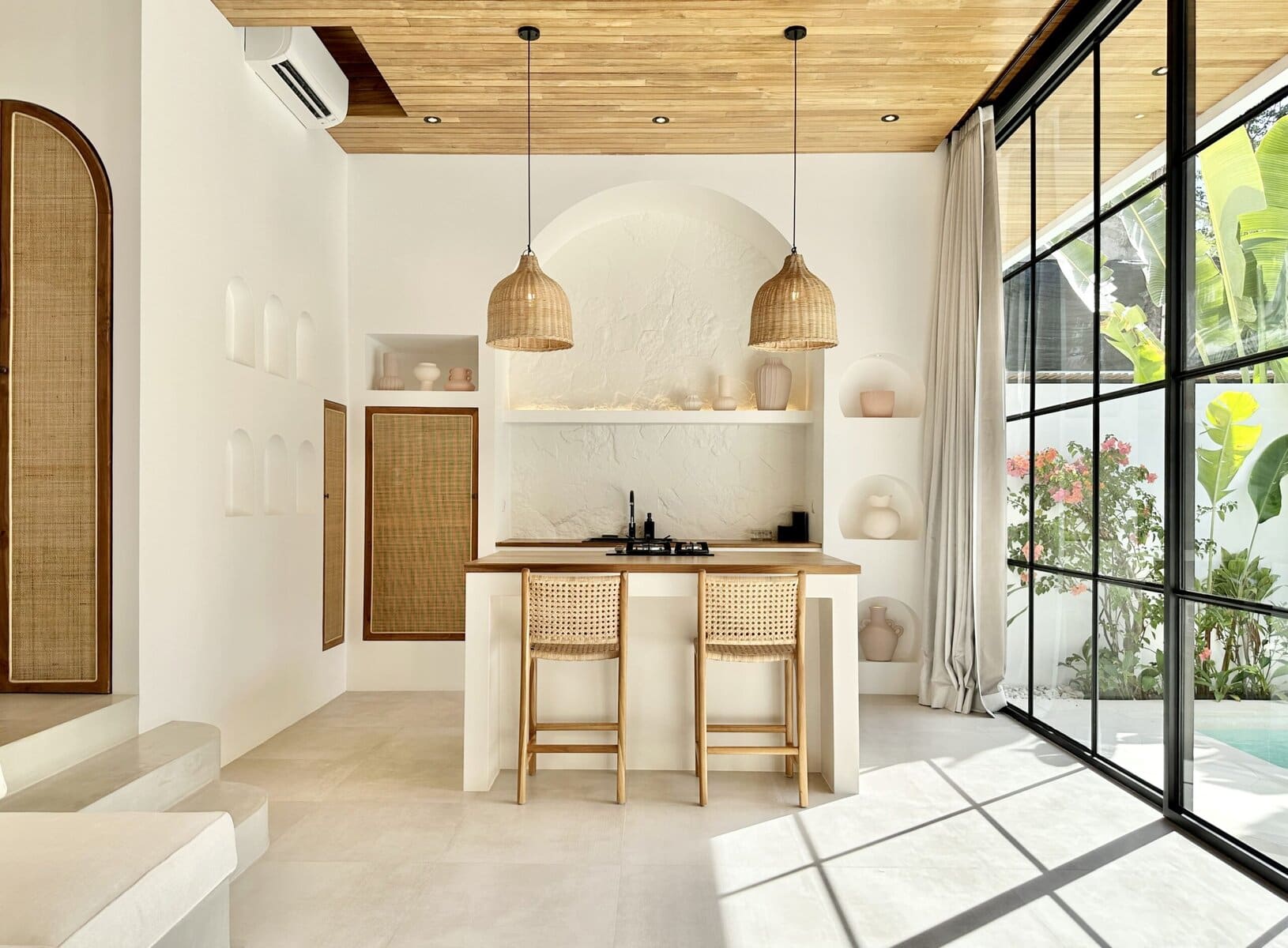 Modern Balinese vacation rental with open kitchen and tropical decor.