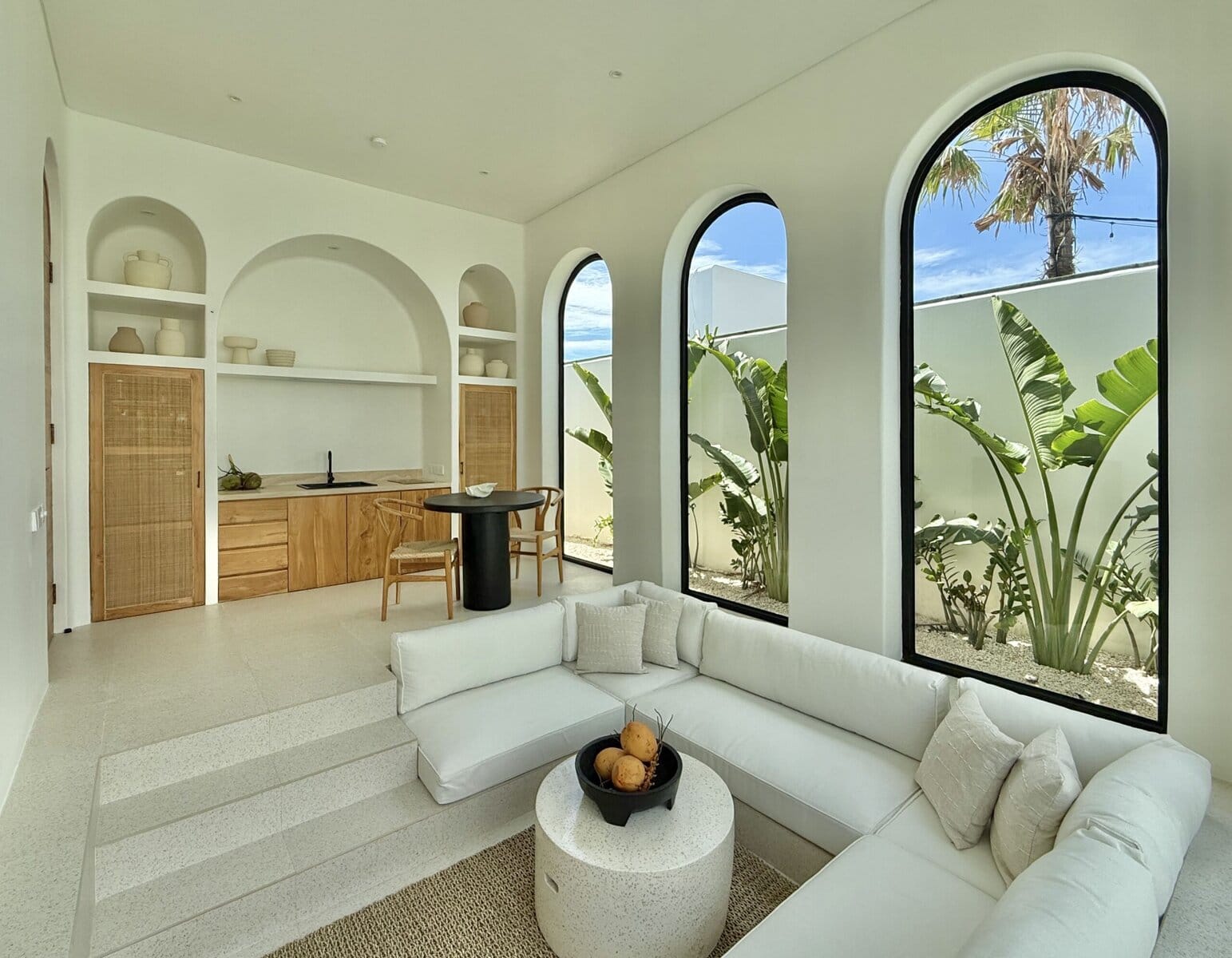 Beautiful modern Bali villa with large arched windows and tropical decor. Perfect for a relaxing Uluwatu getaway.