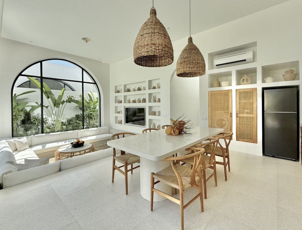 Spacious living area in a premium Uluwatu villa with minimalist aesthetic and tropical accents.