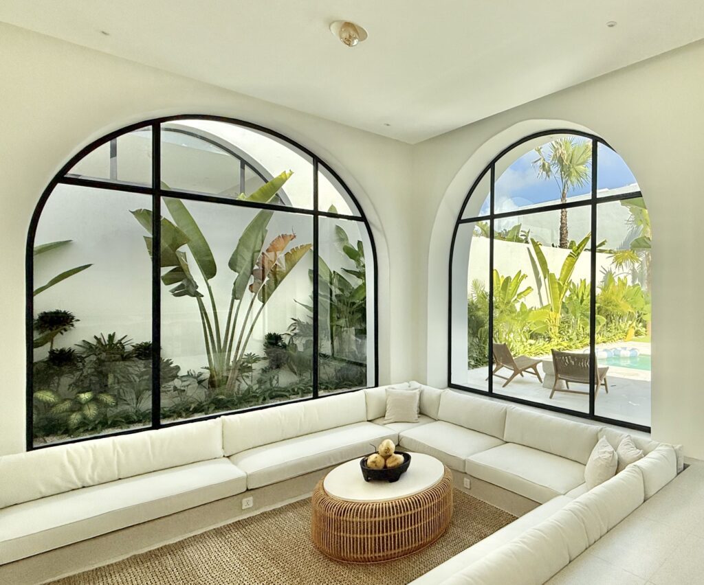 Bright, modern living room with tropical garden views and minimalist decor, perfect for relaxing in Uluwatu.