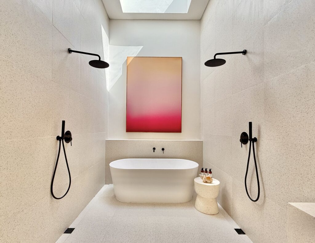 Modern minimalistic Bali en suite with bathtub and black fixtures.