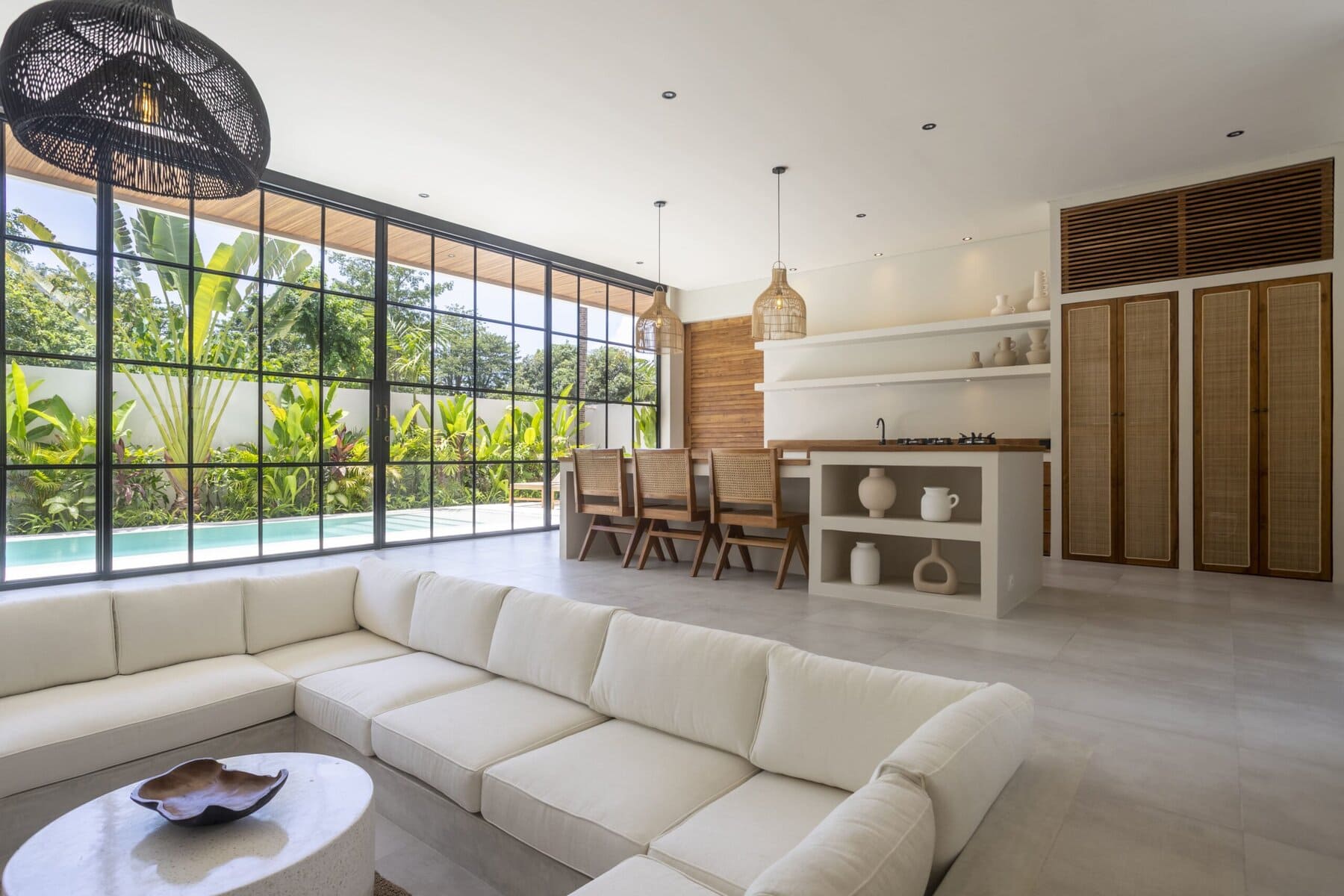 Bright, airy interior with large windows, minimalist decor, and natural materials.