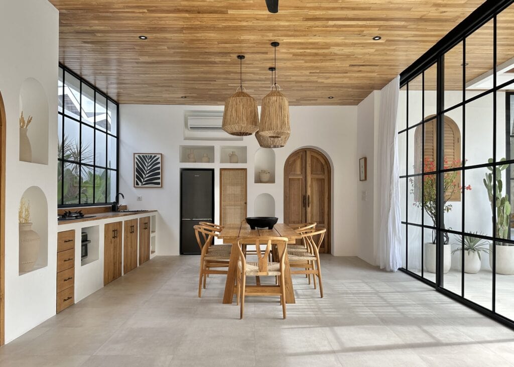 Bright, airy living space with large windows and natural wooden accents.