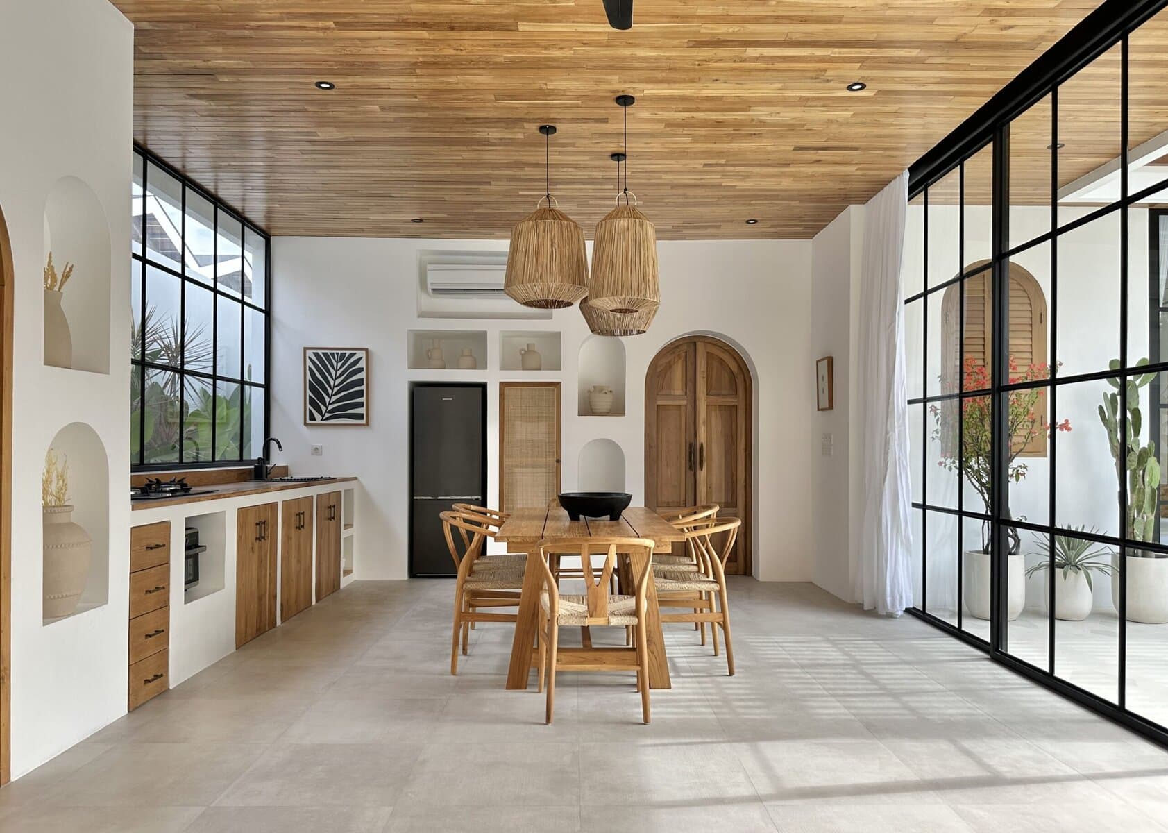 Bright, airy living space with large windows and natural wooden accents.