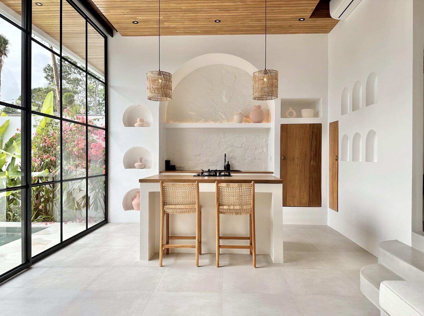 Spacious, modern retreat in Bingin, Uluwatu featuring sleek minimalist decor, natural wood accents, and large glass windows.