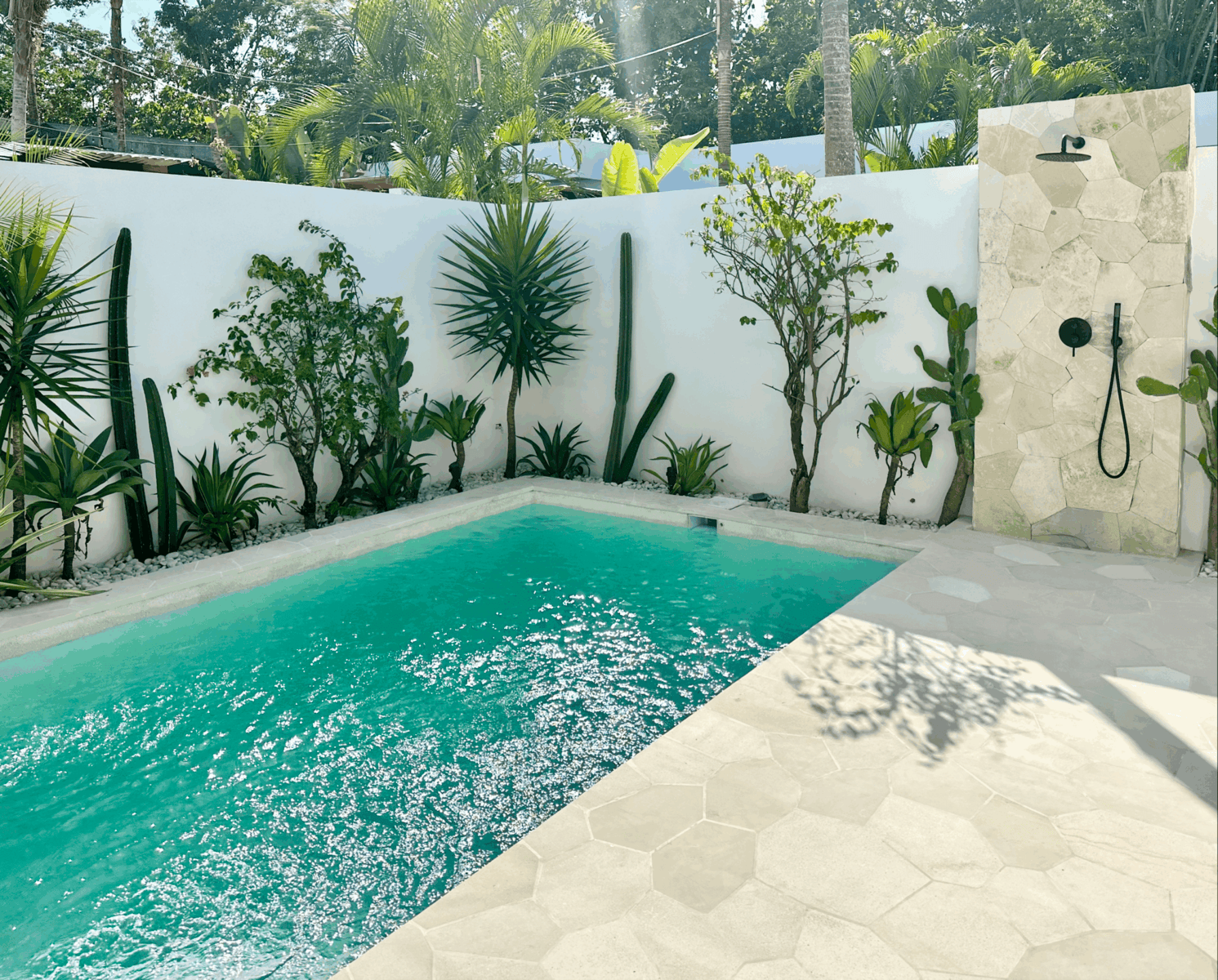 High-end tropical-modern villa with pool and lush greenery, perfect for a premium Bali getaway.