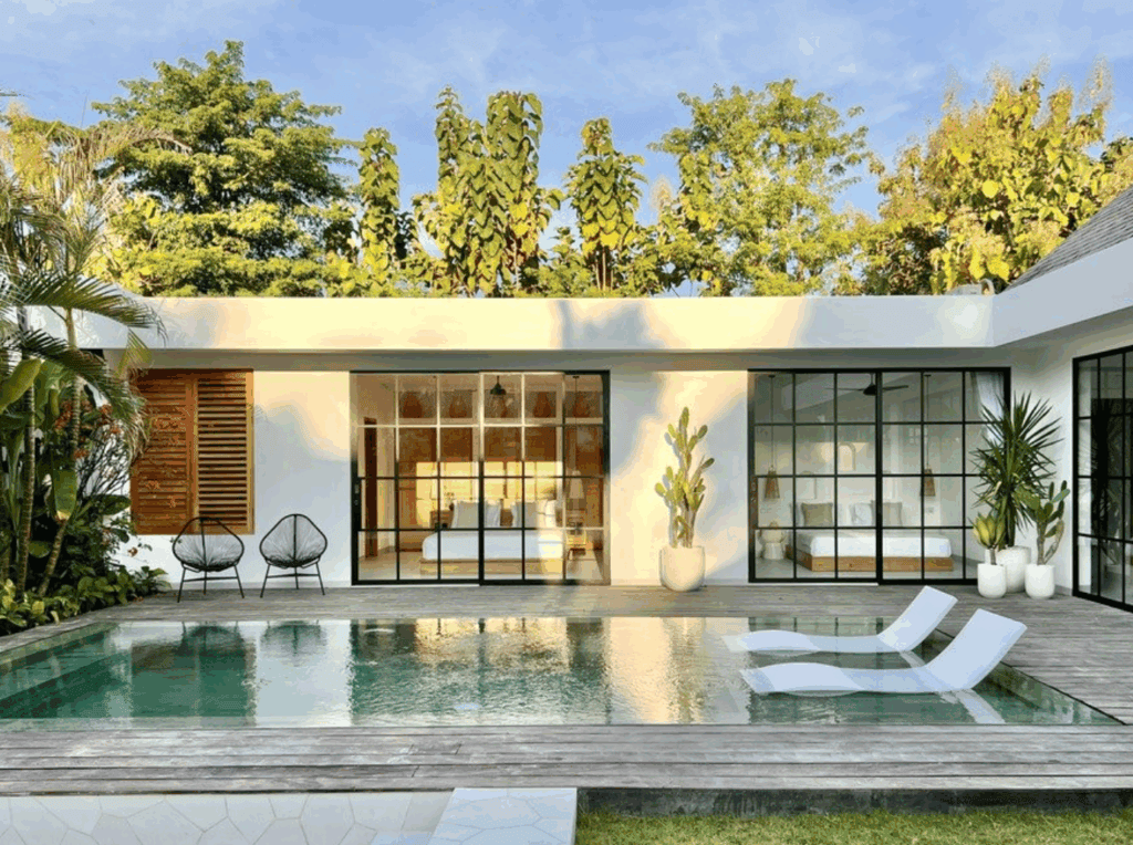 Modern villa with pool, lush garden.