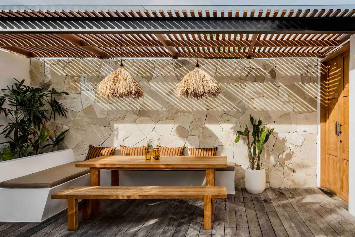 Modern tropical outdoor dining space with natural materials.