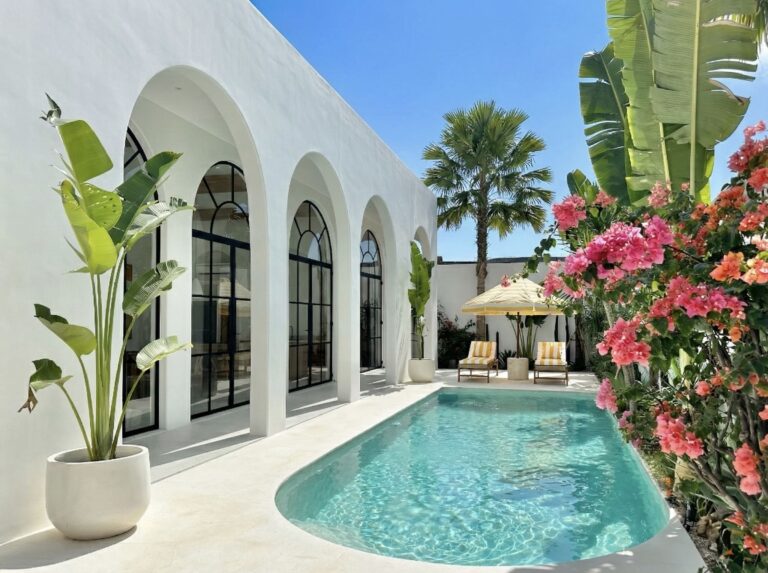 Contemporary tropical architecture design with flat roof and arched detailing.