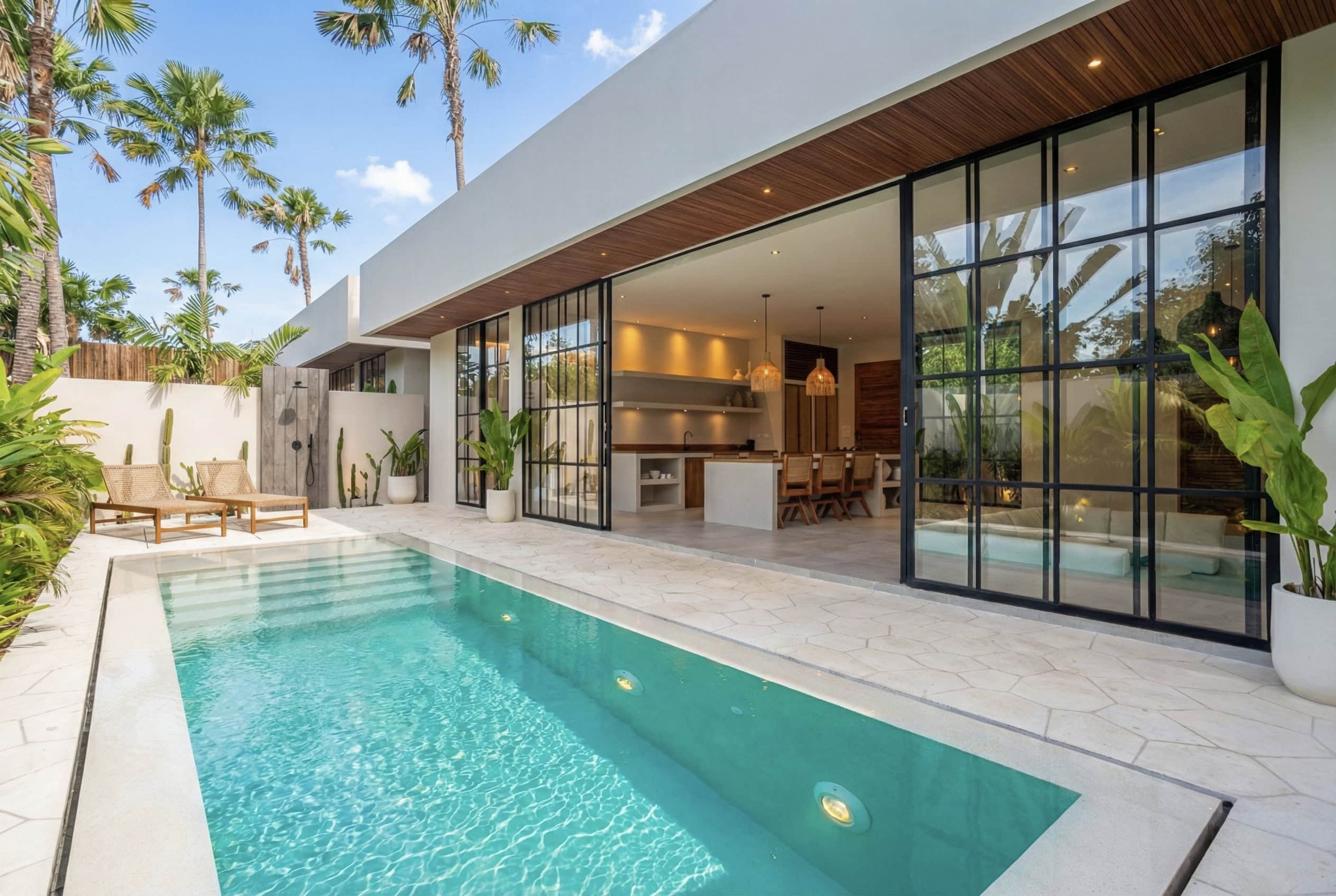 Modern rental in Uluwatu, Bali, showcasing a sleek infinity pool and open-plan living area with floo.
