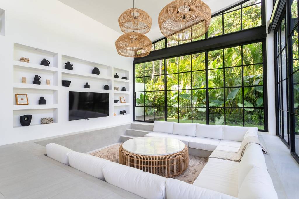 Bright, spacious living room with minimalist decor and large glass windows.