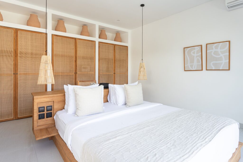 High-end minimalist bedroom with wooden accents and soft neutral tones in Uluwatu.