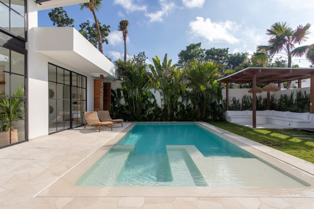 Stylish modern villa with private pool, lush tropical garden, and contemporary interiors in Uluwatu, Bali.