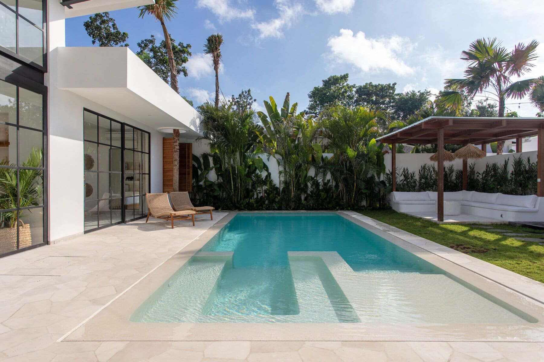 Stylish modern villa with private pool, lush tropical garden, and contemporary interiors in Uluwatu, Bali.