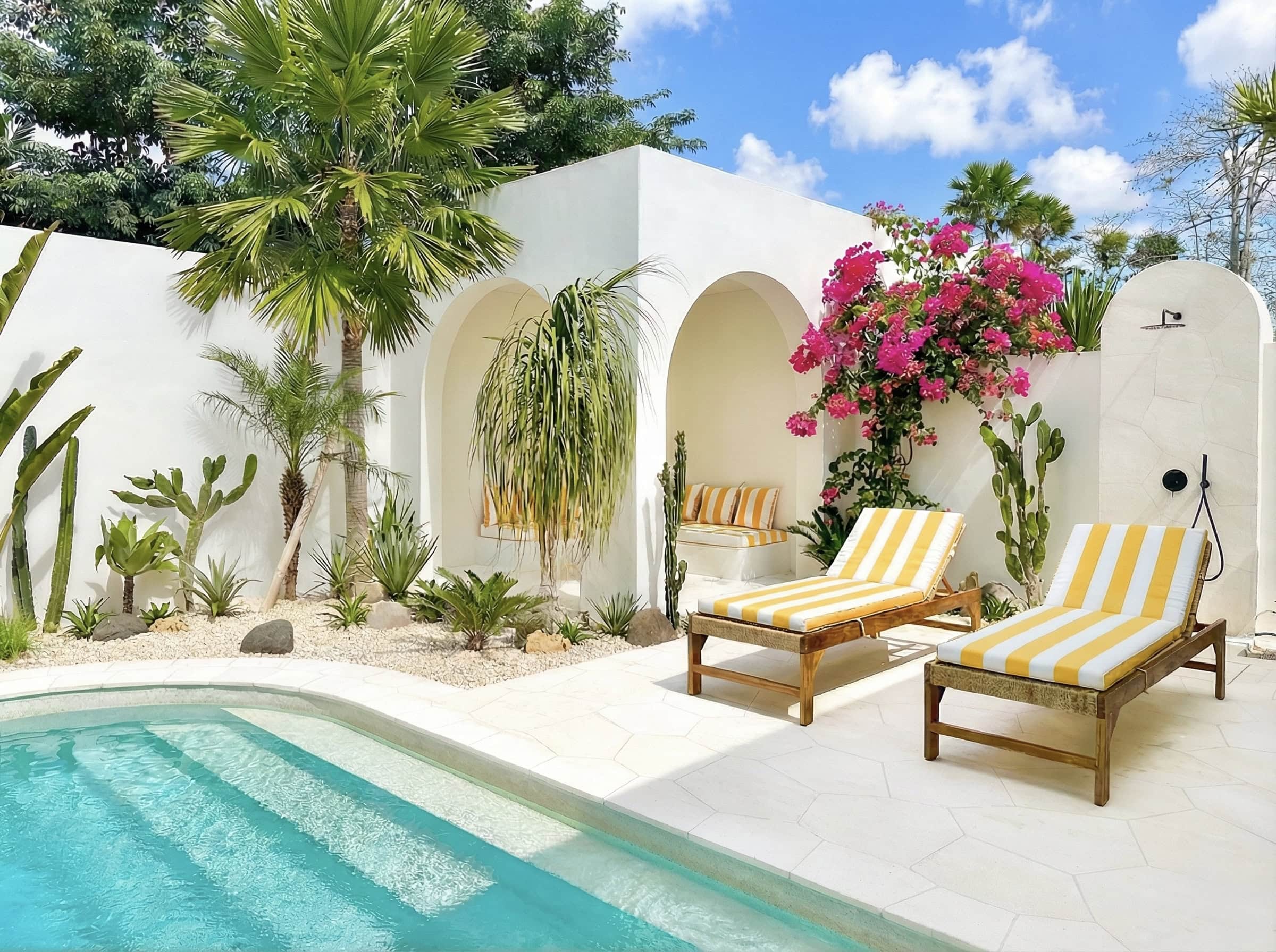 The Young Villas: Elegant tropical-modern poolside lounge with sunbeds and lush greenery in Uluwatu,.