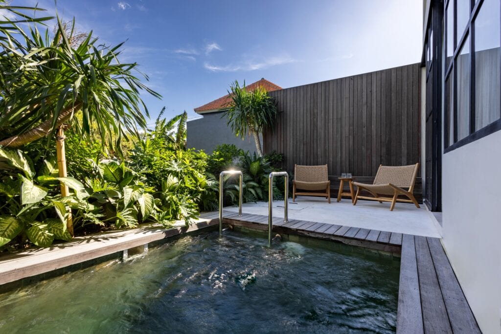 A serene villa with a private pool, lush greenery, and minimalist decor, perfect for a tropical Bali getaway.