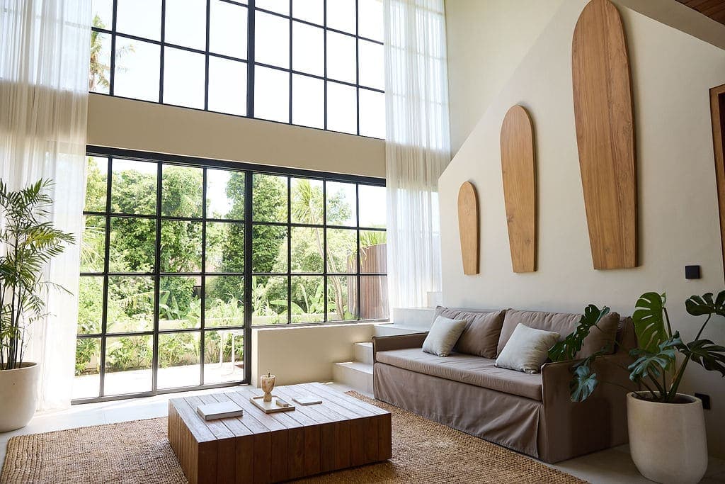 Bright airy living room with large windows and modern decor.