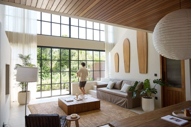 Luxurious tropical-modern living room in a Bali vacation rental, featuring high ceilings and natural light.