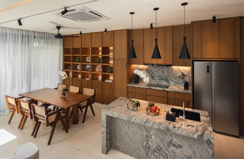 Modern minimalist Bali townhouse kitchen with warm wood cabinets and marble countertops. Perfect for a tropical retreat.
