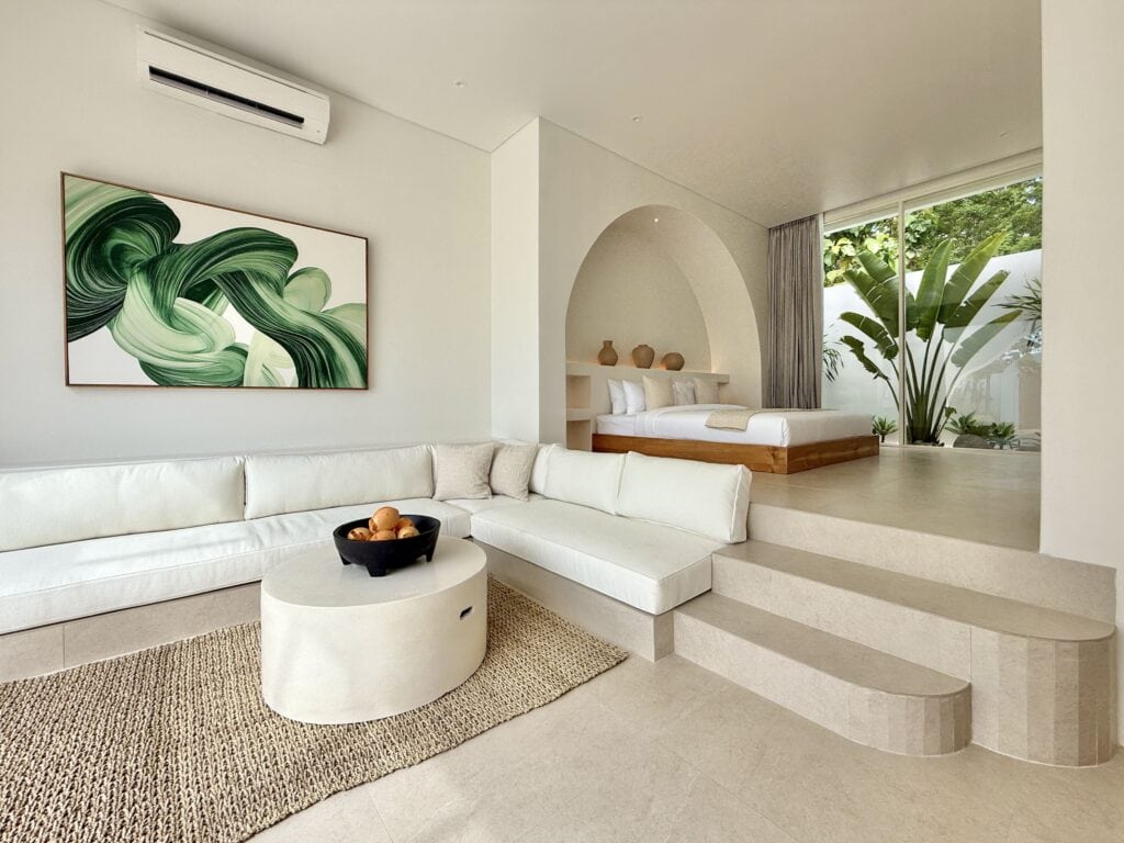 Modern tropical interior with lush greenery view.