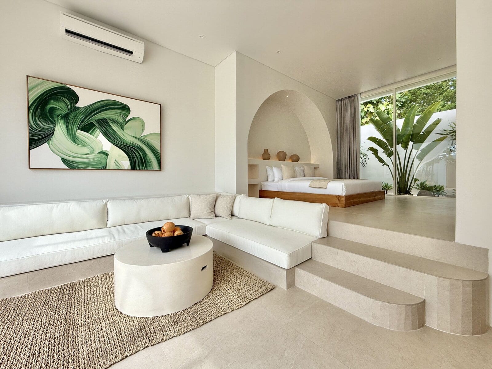 Modern tropical interior with lush greenery view.