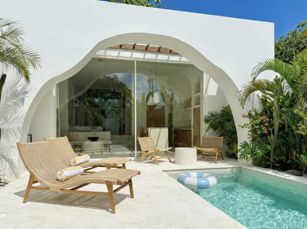 Stylish Bali villa with pool, surrounded by lush tropical greenery, perfect for a relaxing getaway.