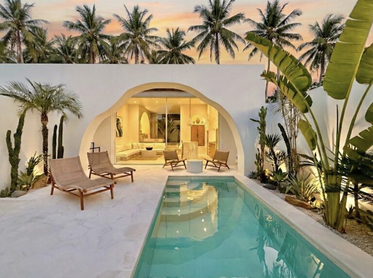 Modern tropical villa with private pool, lush greenery, and sunset view. Perfect for a luxurious vacation stay.