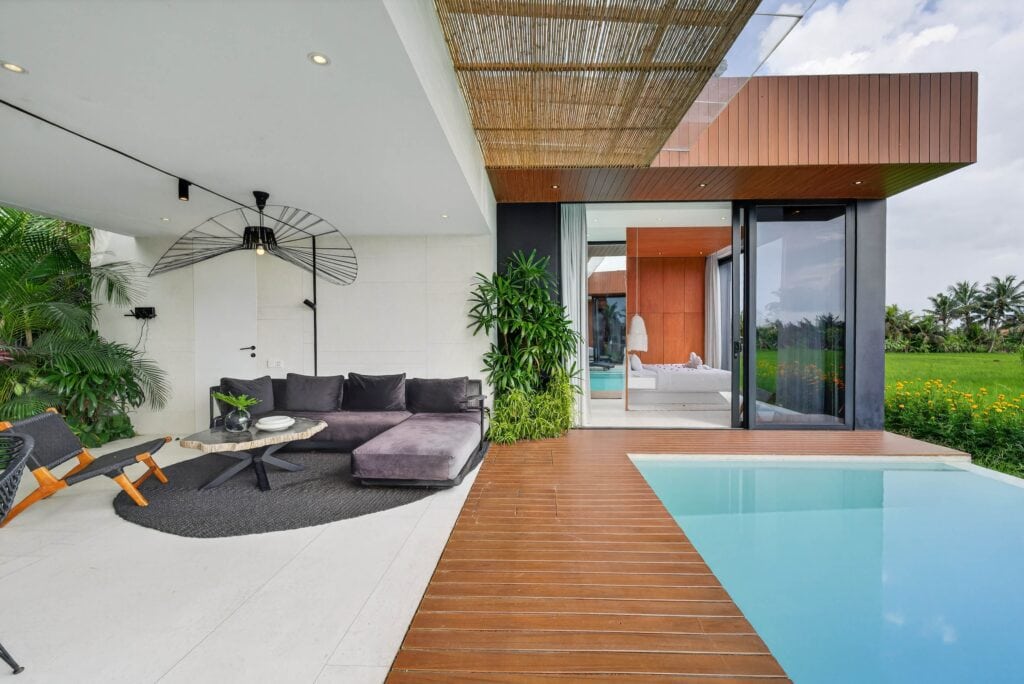 High-end outdoor living space with infinity pool, modern lounge, and tropical greenery in Uluwatu.