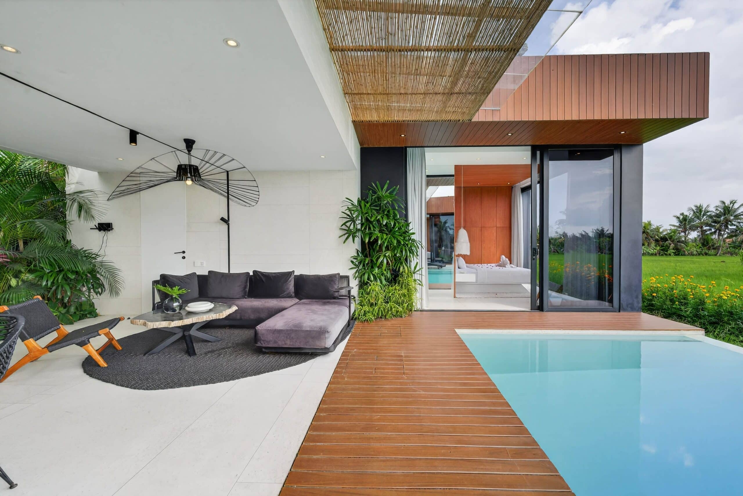 High-end outdoor living space with infinity pool, modern lounge, and tropical greenery in Uluwatu.