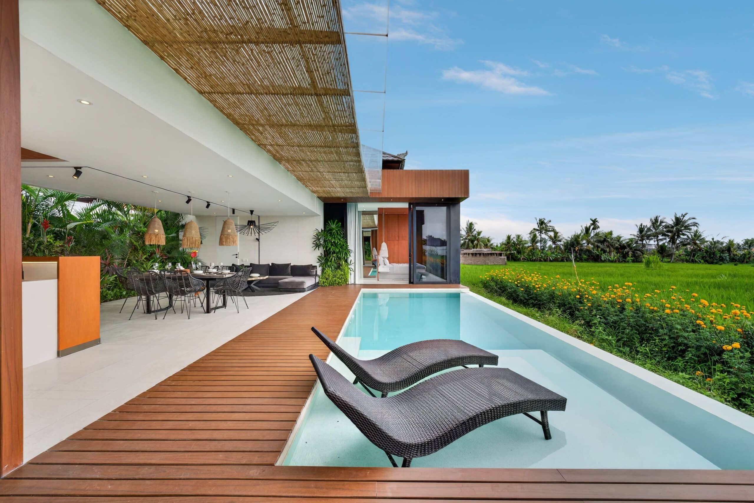 Luxury tropical-modern villa in Canggu with private infinity pool and modern outdoor lounge.
